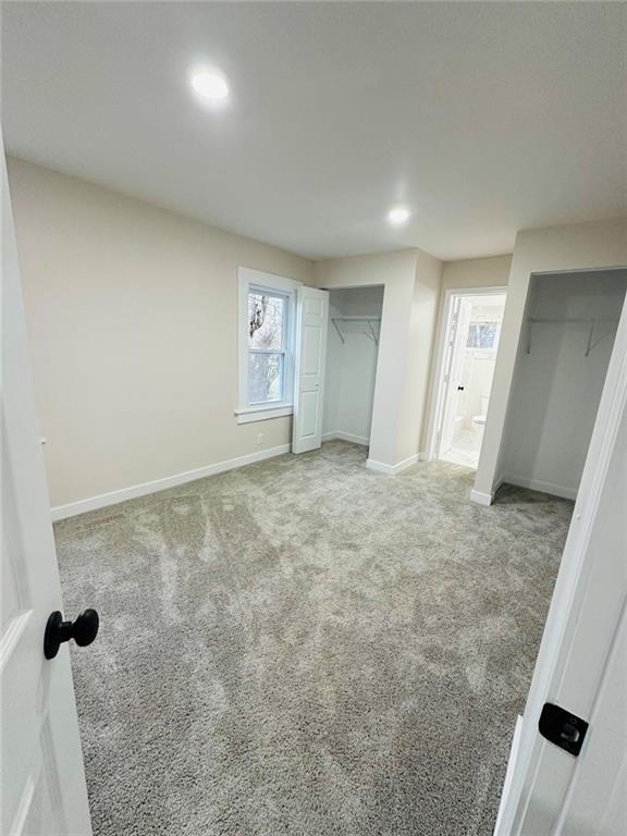 unfurnished bedroom with light colored carpet