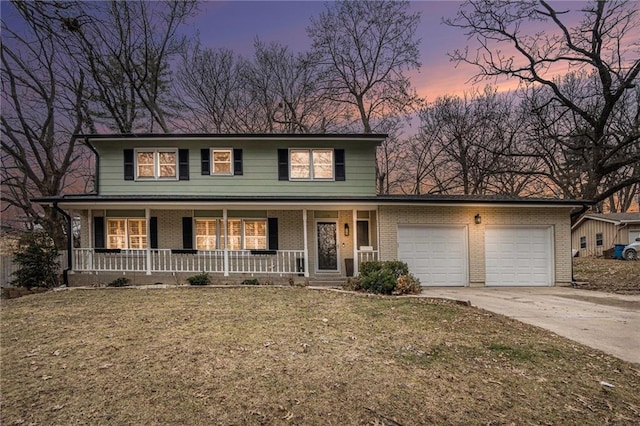 view of front facade with a yard, a garage, and covered porch