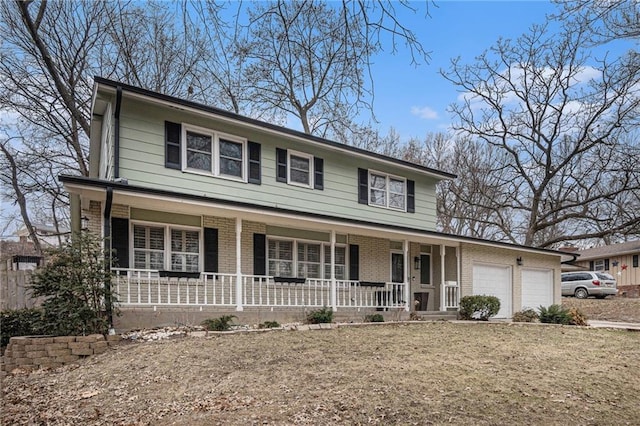 view of front of home featuring a garage, a porch, and a front lawn