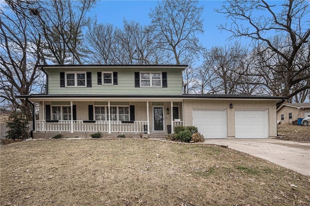 view of front of home with a garage, a front lawn, and a porch