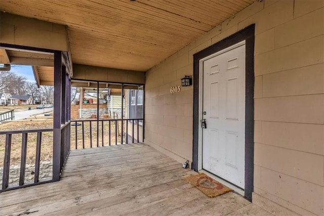 property entrance with concrete block siding and covered porch