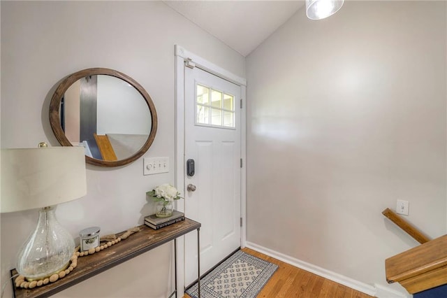 entryway featuring lofted ceiling and light wood-type flooring