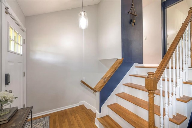 stairway with hardwood / wood-style flooring