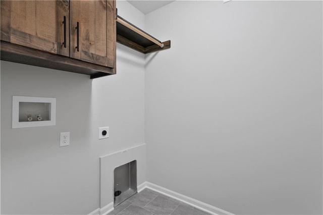 laundry room with cabinets, electric dryer hookup, hookup for a washing machine, and tile patterned flooring