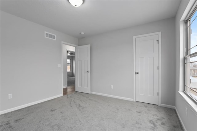 unfurnished bedroom with light carpet