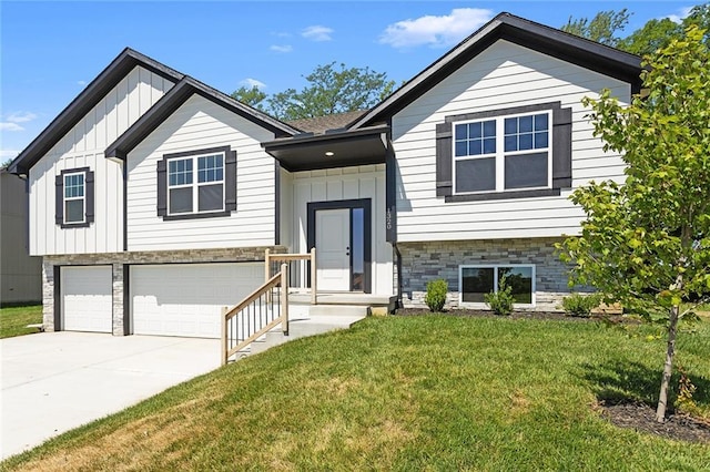 1320 N Holland Ct, Independence, MO 64056 - raised ranch featuring board and batten siding, a garage, a front lawn, driveway, and stone siding