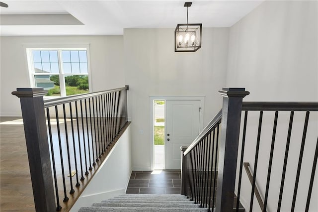 1320 N Holland Ct, Independence, MO 64056 - staircase with a chandelier and baseboards