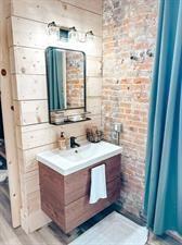 218/220 N Main St, Maryville, MO 64468 - bathroom featuring vanity and brick wall