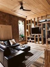218/220 N Main St, Maryville, MO 64468 - home theater featuring hardwood / wood-style flooring, brick wall, wooden ceiling, and ceiling fan