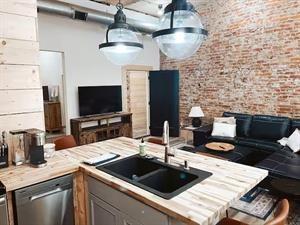 218/220 N Main St, Maryville, MO 64468 - kitchen with sink, gray cabinets, dishwasher, and brick wall