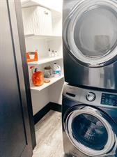 218/220 N Main St, Maryville, MO 64468 - clothes washing area featuring light hardwood / wood-style flooring and stacked washer and clothes dryer