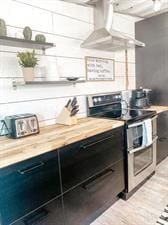 218/220 N Main St, Maryville, MO 64468 - kitchen with double oven range, wood counters, and range hood