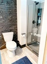 218/220 N Main St, Maryville, MO 64468 - bathroom with hardwood / wood-style floors, a shower, and toilet