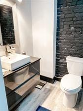 218/220 N Main St, Maryville, MO 64468 - bathroom with vanity, hardwood / wood-style flooring, and toilet
