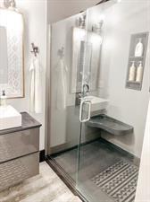 218/220 N Main St, Maryville, MO 64468 - bathroom featuring walk in shower, vanity, and hardwood / wood-style floors