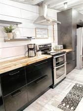 218/220 N Main St, Maryville, MO 64468 - kitchen with white cabinetry, refrigerator, extractor fan, and range with two ovens