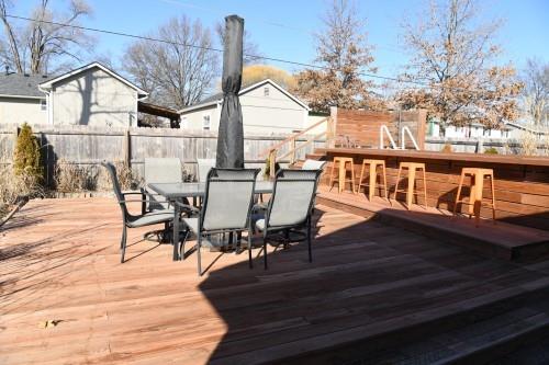 wooden terrace featuring exterior bar