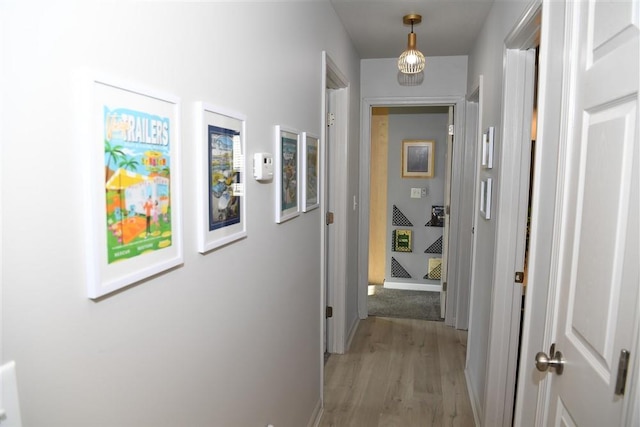 corridor with light hardwood / wood-style flooring