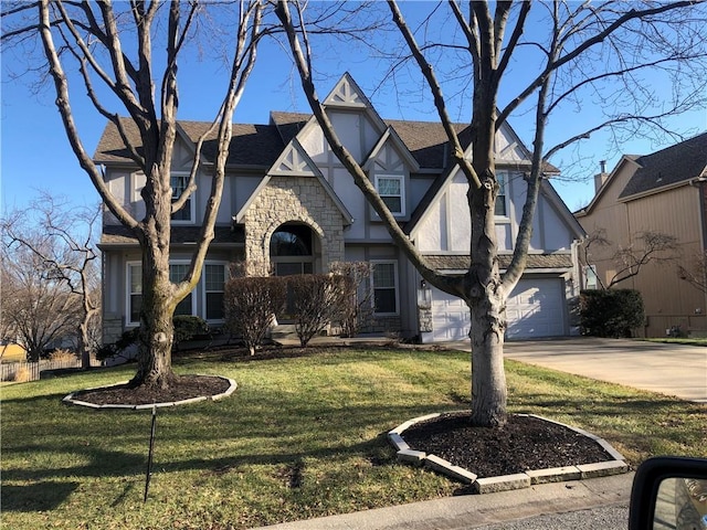 tudor home featuring stone siding, a front yard, concrete driveway, and stucco siding