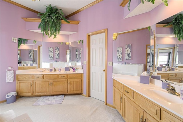 bathroom with crown molding, two vanities, and a sink