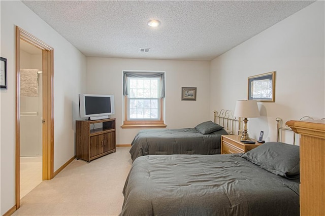 carpeted bedroom with visible vents, a textured ceiling, and baseboards