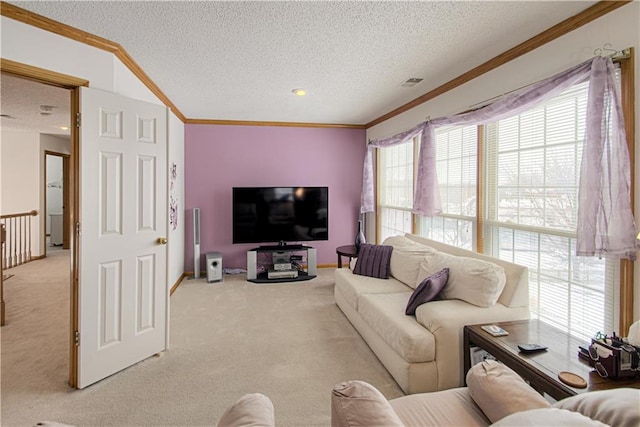 living room featuring ornamental molding, light carpet, visible vents, and a textured ceiling