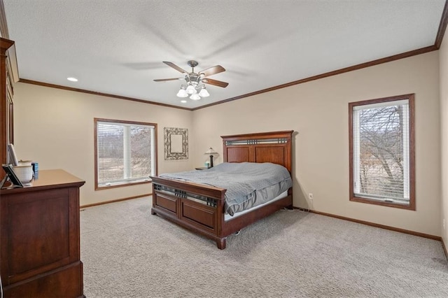 carpeted bedroom with ceiling fan and ornamental molding