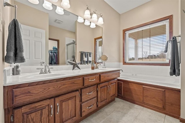 bathroom featuring tile patterned floors, plus walk in shower, and vanity