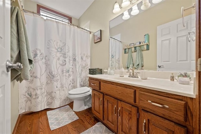 bathroom with vanity, wood-type flooring, and toilet