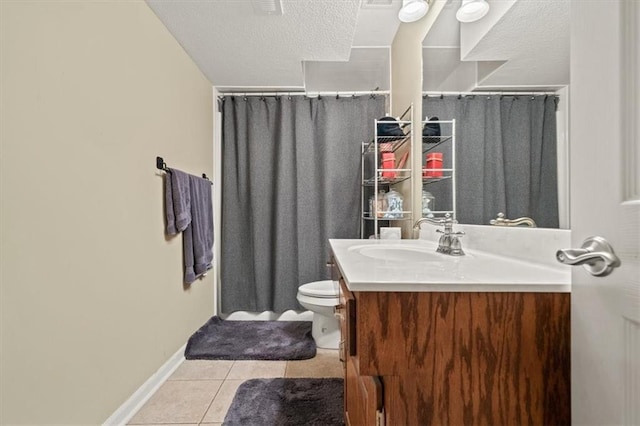 bathroom with vanity, tile patterned floors, toilet, and a textured ceiling