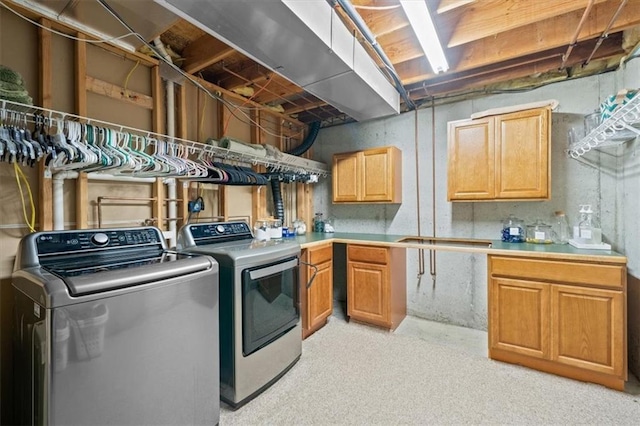 laundry area featuring washer and dryer and cabinets