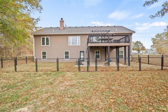 back of house with a yard and a deck