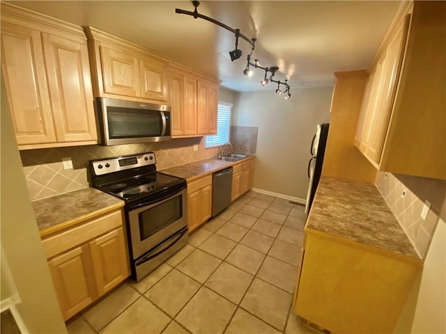 kitchen featuring light tile patterned flooring, sink, light brown cabinets, appliances with stainless steel finishes, and decorative backsplash