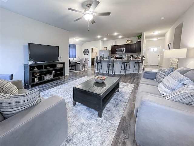 living room featuring dark hardwood / wood-style floors and ceiling fan