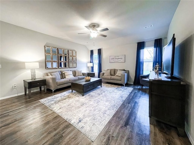 living room with dark hardwood / wood-style flooring and ceiling fan