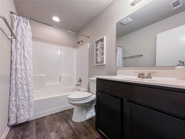 full bathroom featuring shower / tub combo with curtain, wood-type flooring, toilet, and vanity