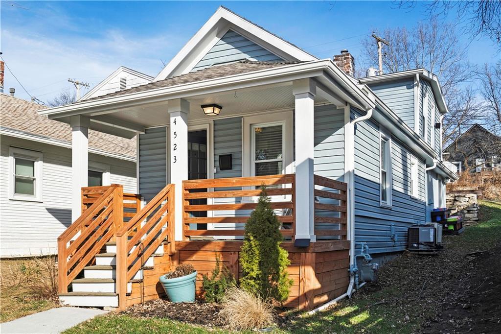 bungalow-style home with central AC unit