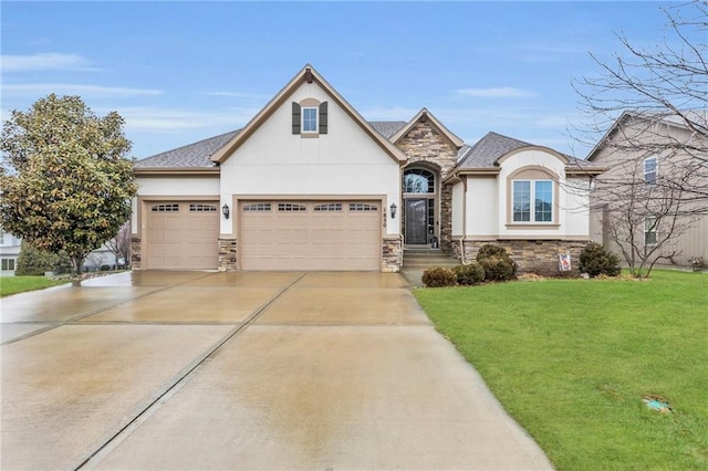 french country home featuring a garage, concrete driveway, stone siding, a front lawn, and stucco siding