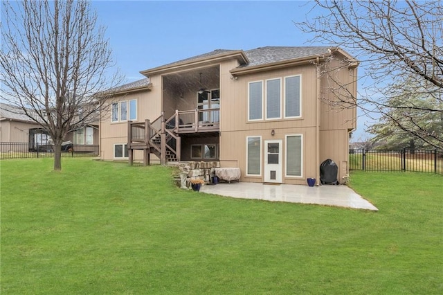 rear view of property with a patio area, a yard, stairway, and a fenced backyard