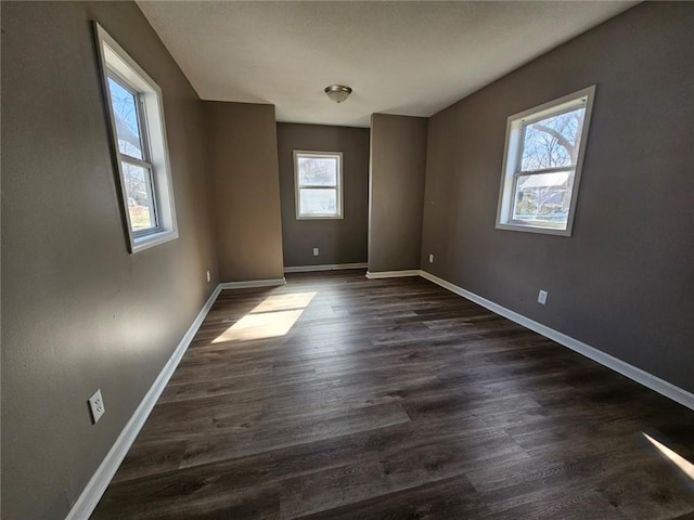 unfurnished room with dark hardwood / wood-style flooring