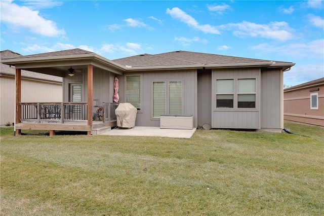 rear view of house with a lawn, a deck, ceiling fan, and a patio area