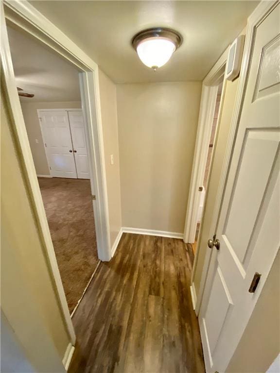 hallway with dark hardwood / wood-style floors