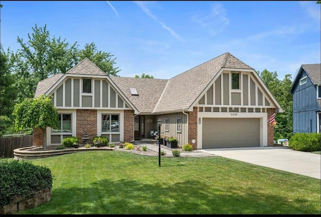 tudor house featuring a garage and a front yard