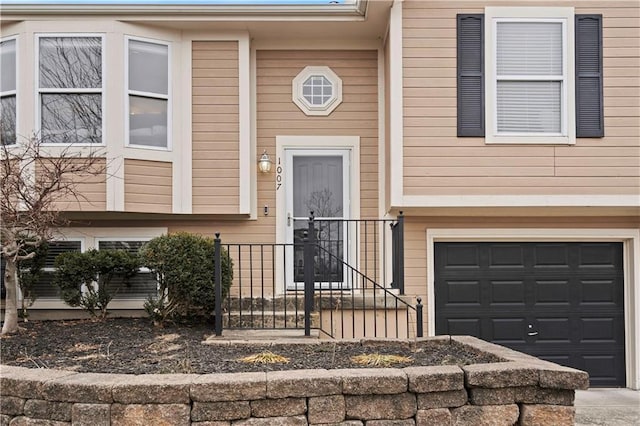 view of exterior entry with a garage