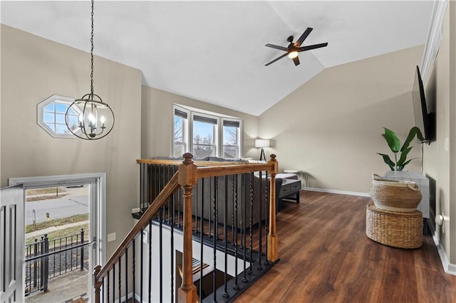 stairway featuring hardwood / wood-style flooring, vaulted ceiling, and ceiling fan with notable chandelier