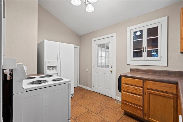 kitchen with white electric stove and vaulted ceiling