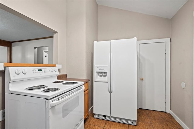 kitchen featuring white appliances and light hardwood / wood-style flooring