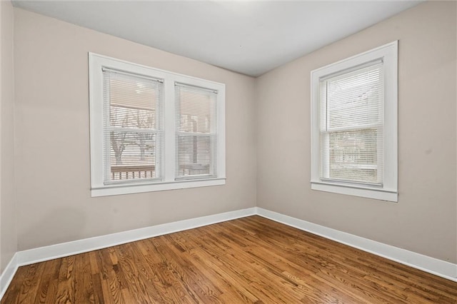 empty room featuring hardwood / wood-style flooring and a wealth of natural light