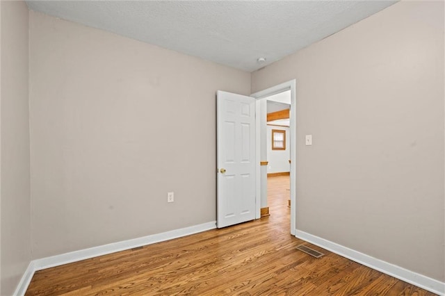 unfurnished room with light hardwood / wood-style floors