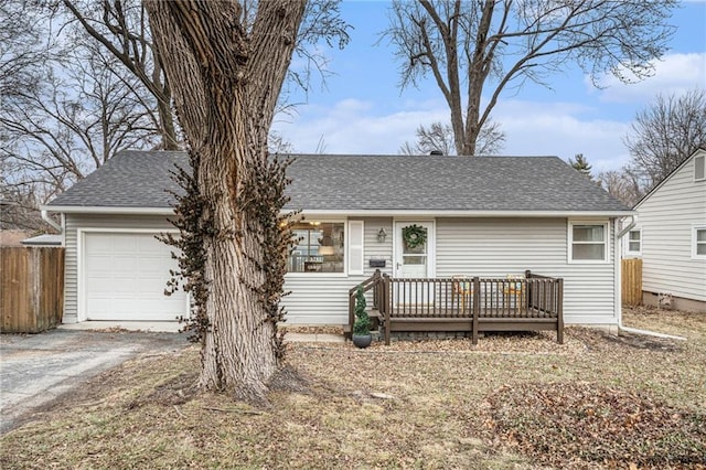 single story home featuring a wooden deck and a garage